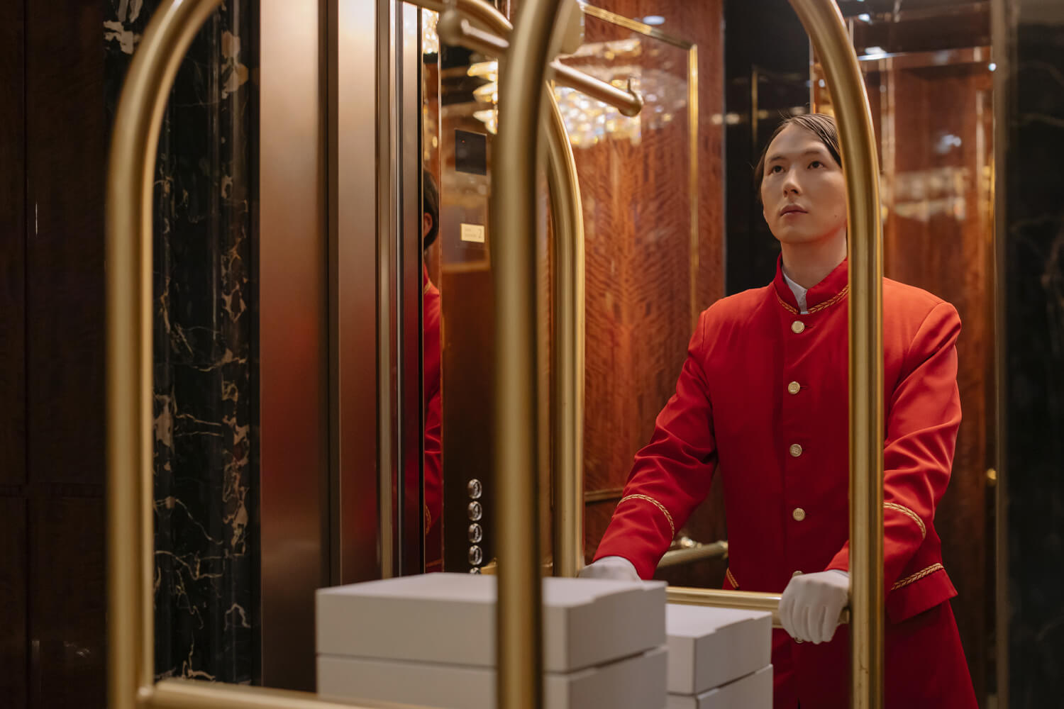 Man Pushing the Cart Outside Hotel Elevator